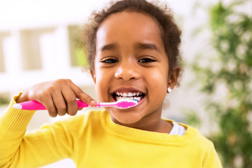 little girl brushing teeth